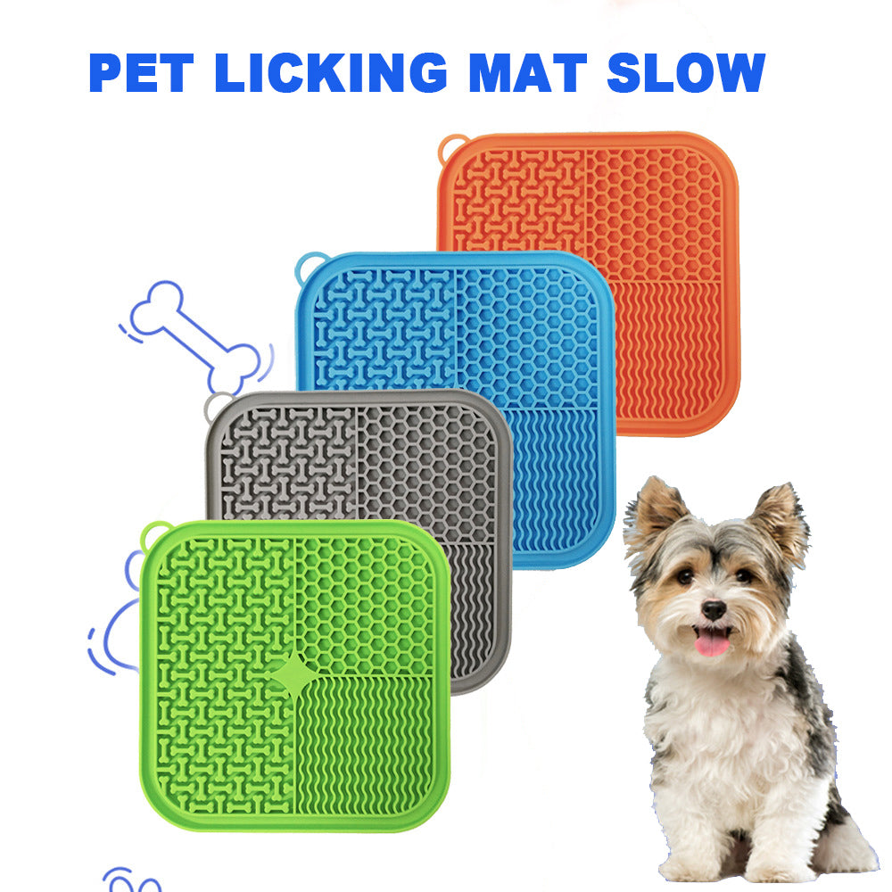 Licking mats in green, blue, orange and grey with a small dog